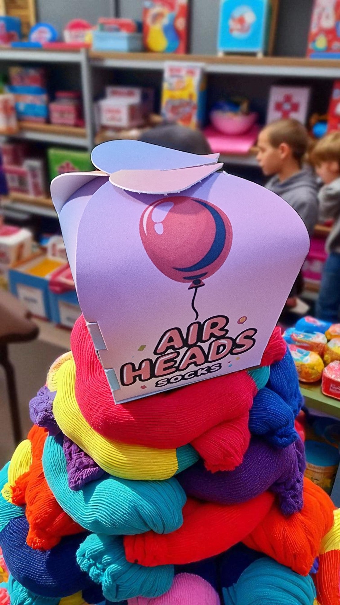 Colorful toy with 'Air Heads' packaging in a store setting
