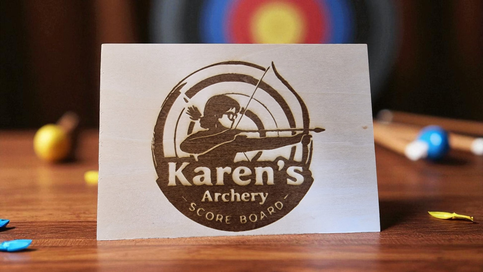 Scoreboard for Karen's Archery with archer and target design on a wooden surface.