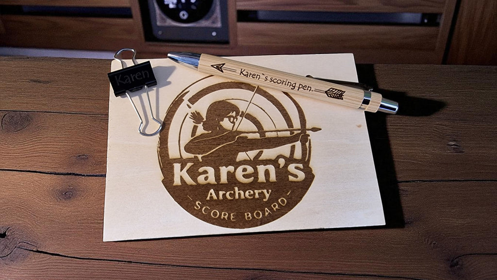 Scoreboard with 'Karen's Archery' branding on a wooden surface