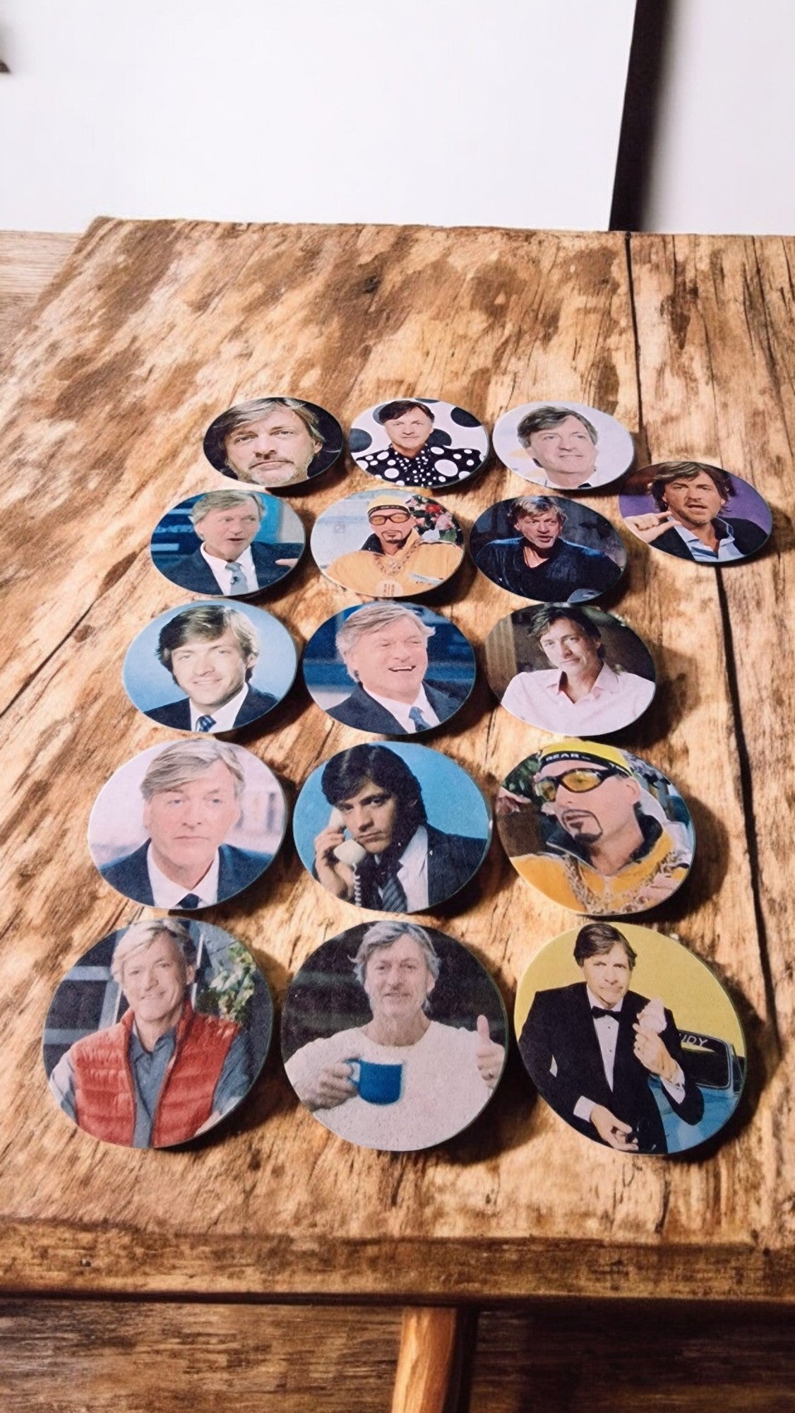 Circular images of people arranged in a circular pattern on a wooden surface