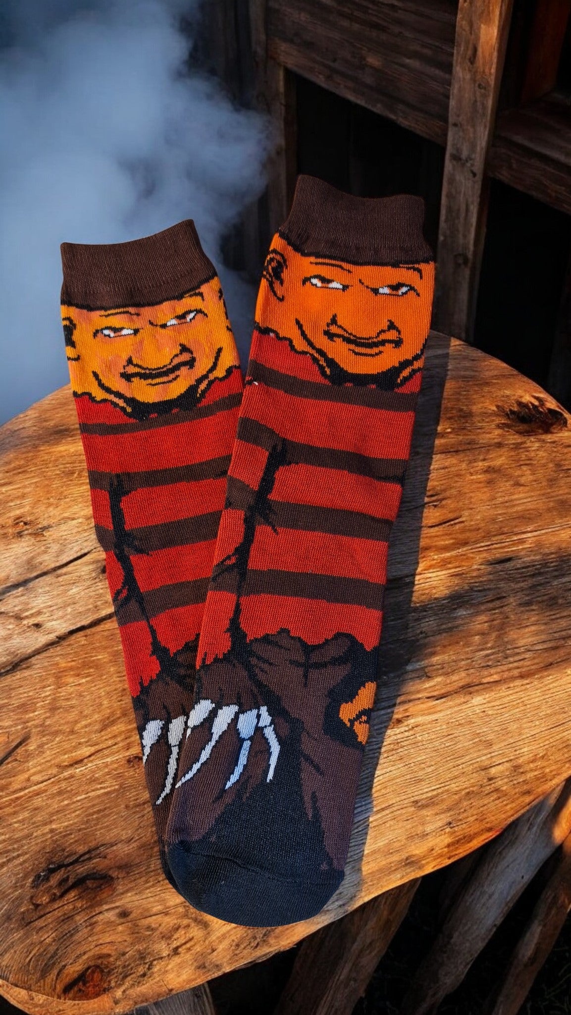 Pair of socks with a character design on a wooden surface
