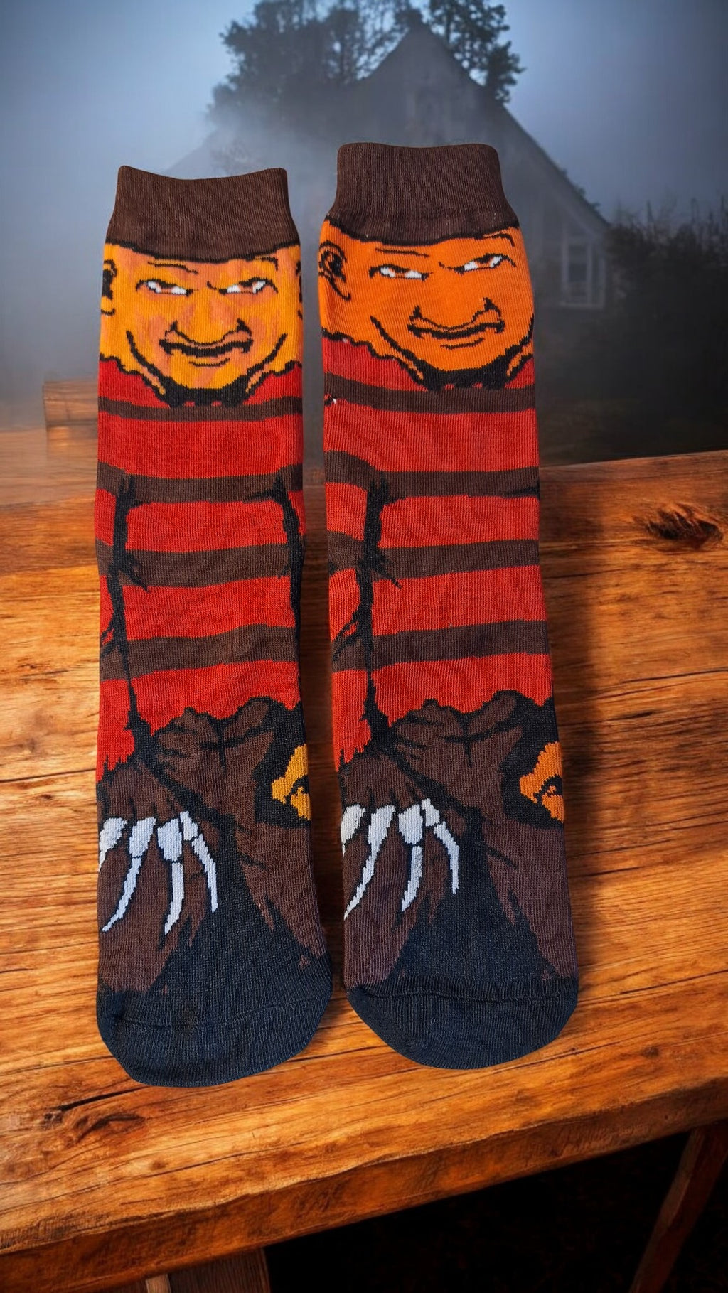 Pair of socks with a character design on a wooden surface