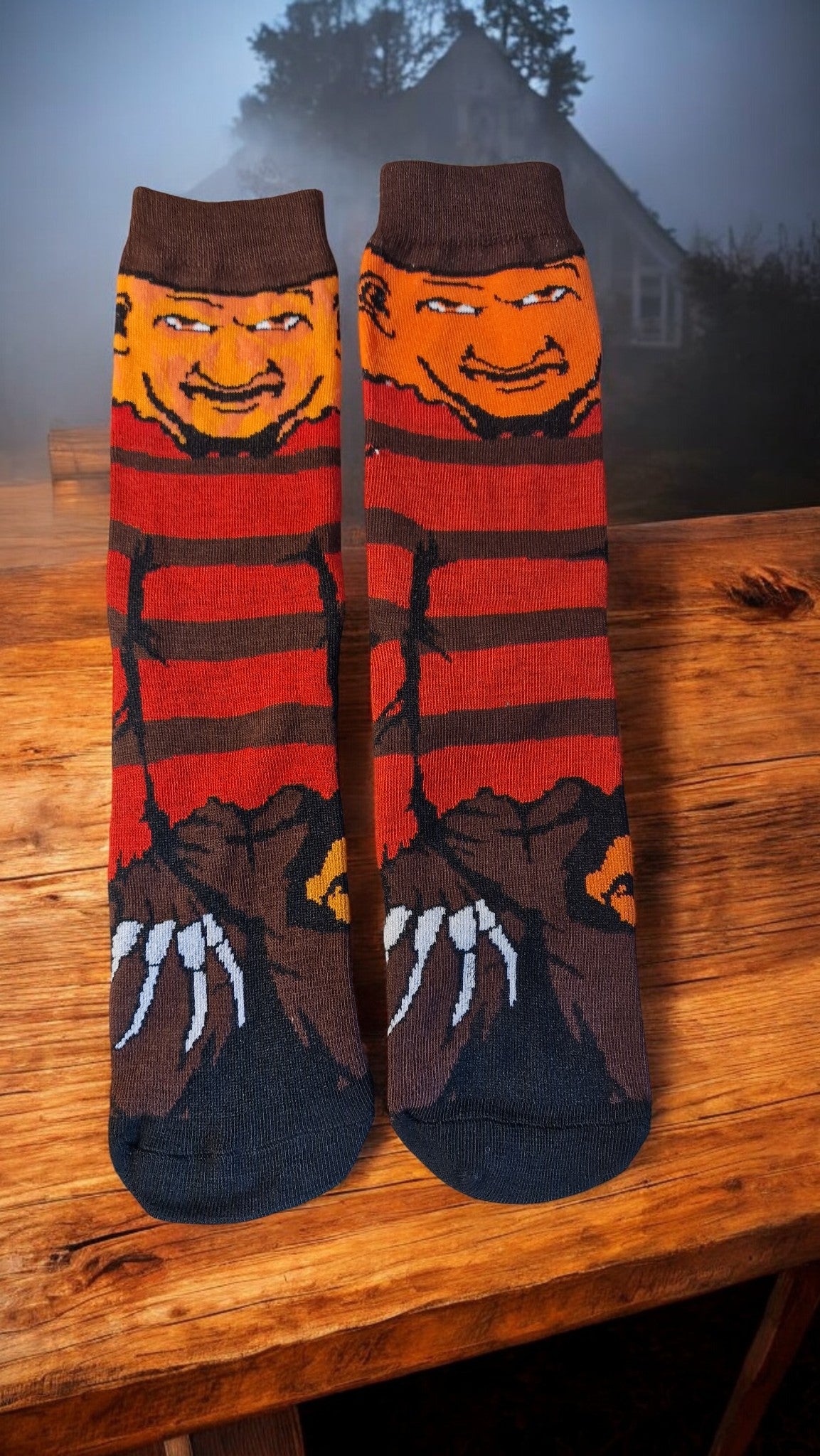 Pair of socks with a character design on a wooden surface