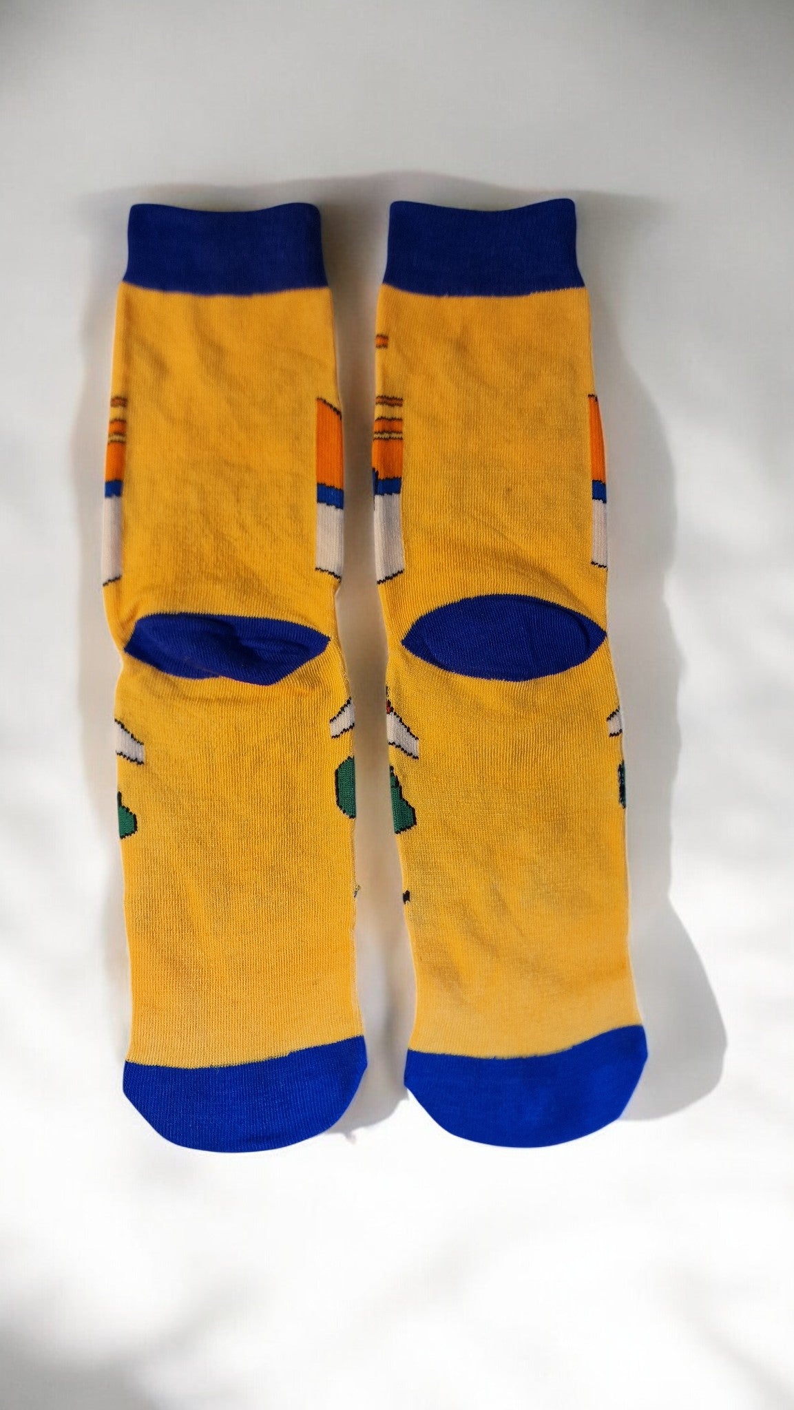 Pair of yellow socks with blue accents on a white background