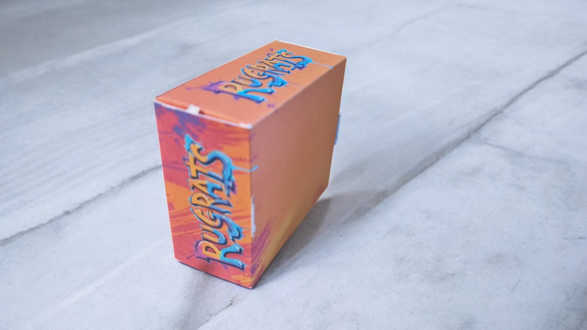 Colorful box with 'Rugrats' branding on a light gray background