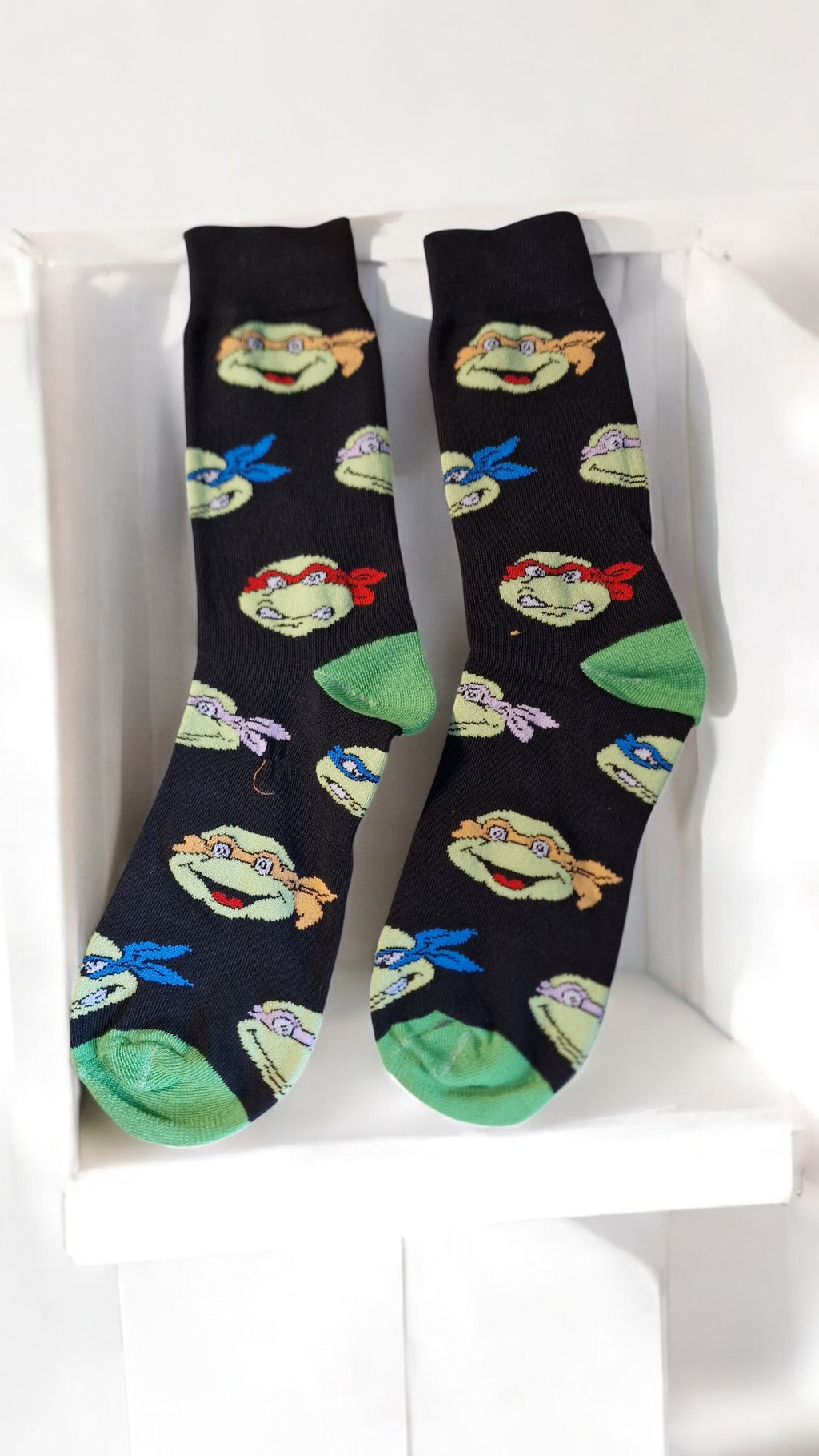 Pair of socks with cartoon character design on a white background
