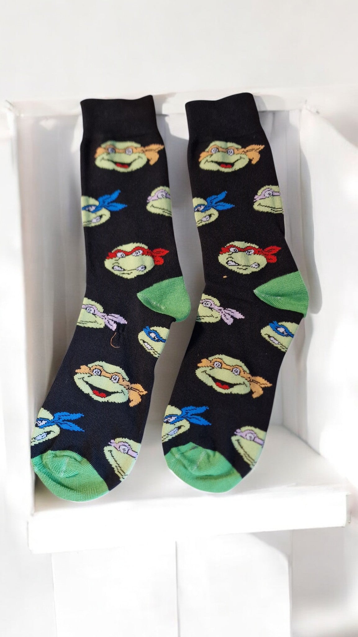 Pair of socks with cartoon character design on a white background