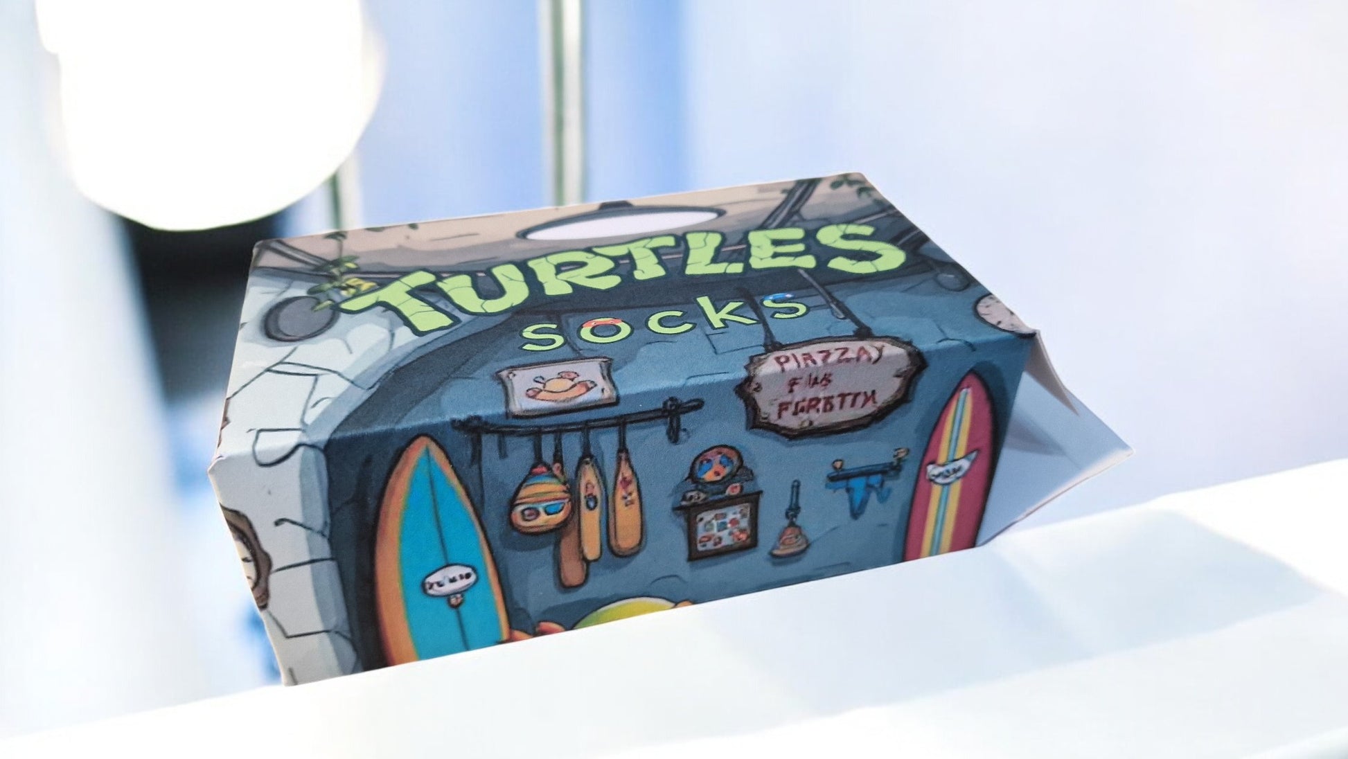 Box of 'Turtles Socks' with a surfboard and beach-themed design on a white background