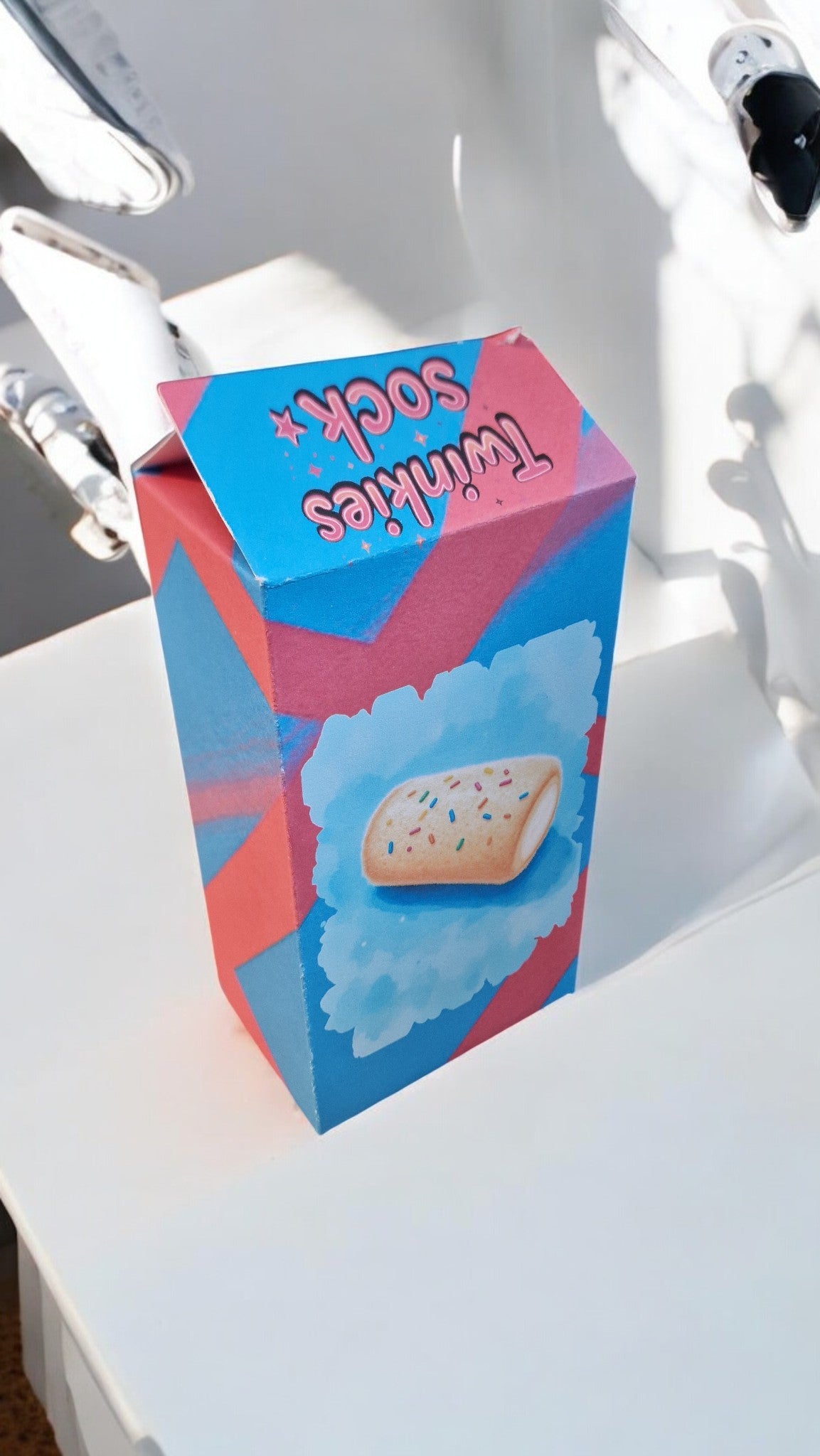 Colorful box of Twinkies on a white surface with a blurred background