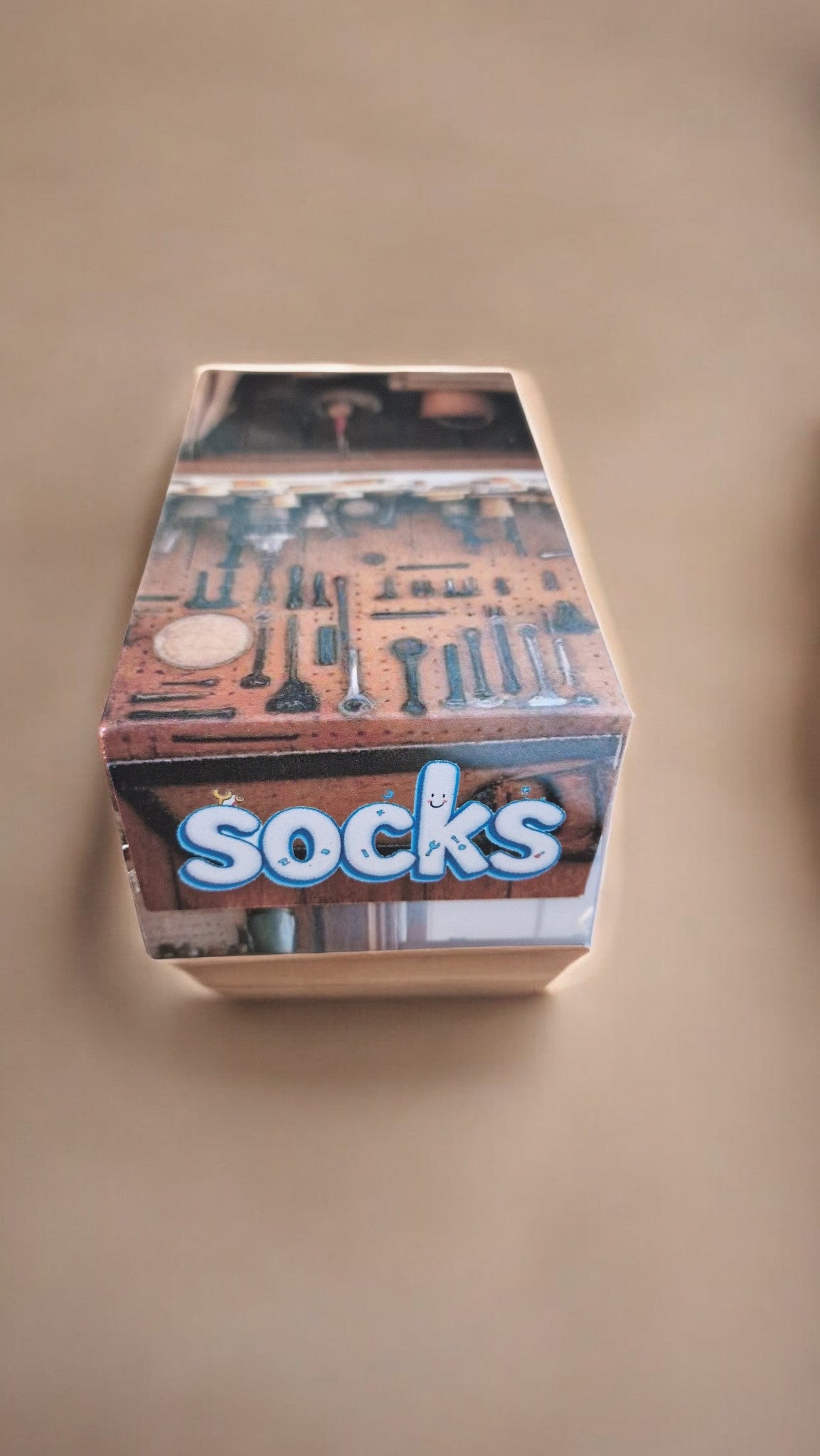 Box of socks with a store front design on a beige background