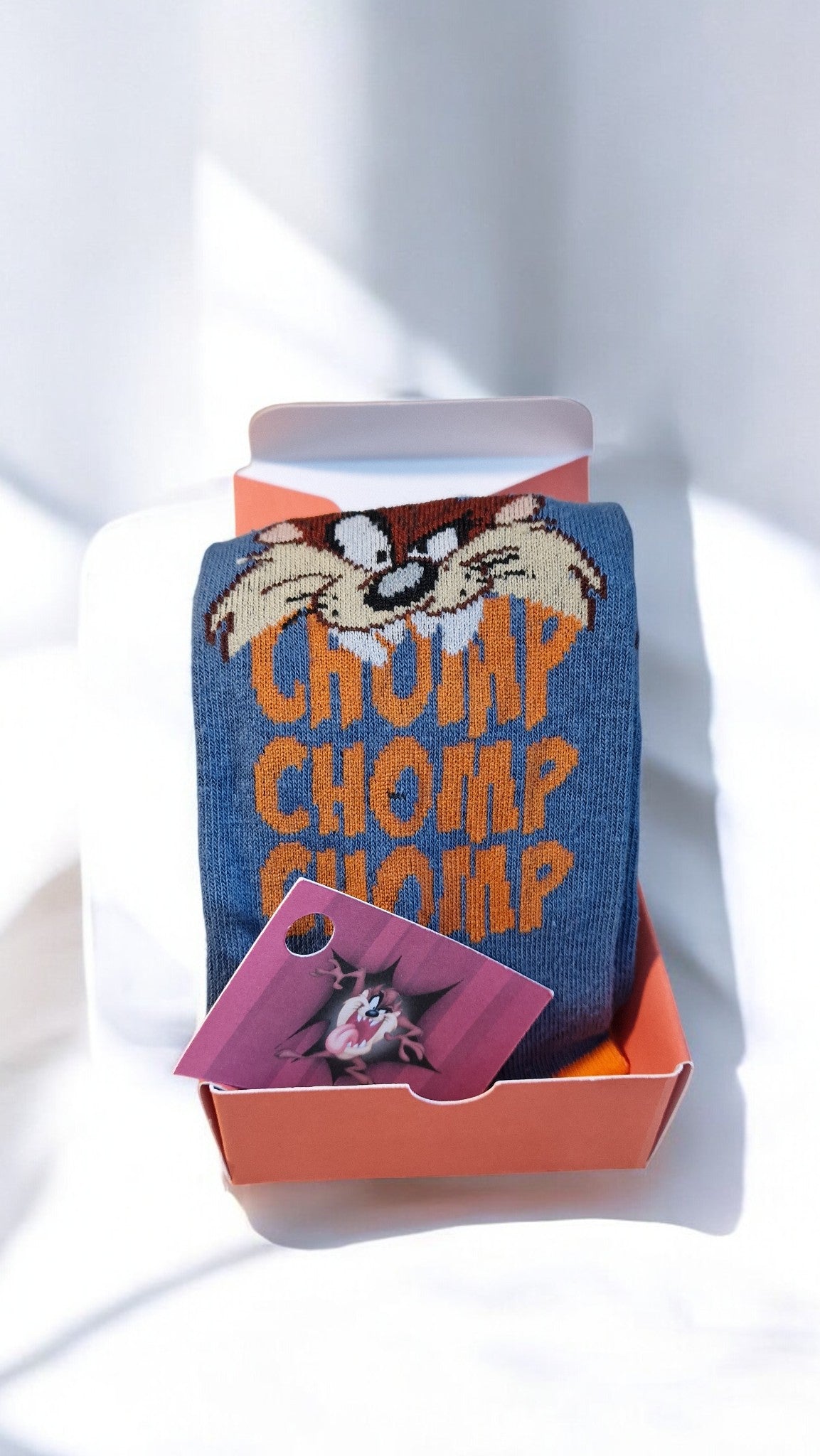 Socks with cartoon character design in a box on a white background