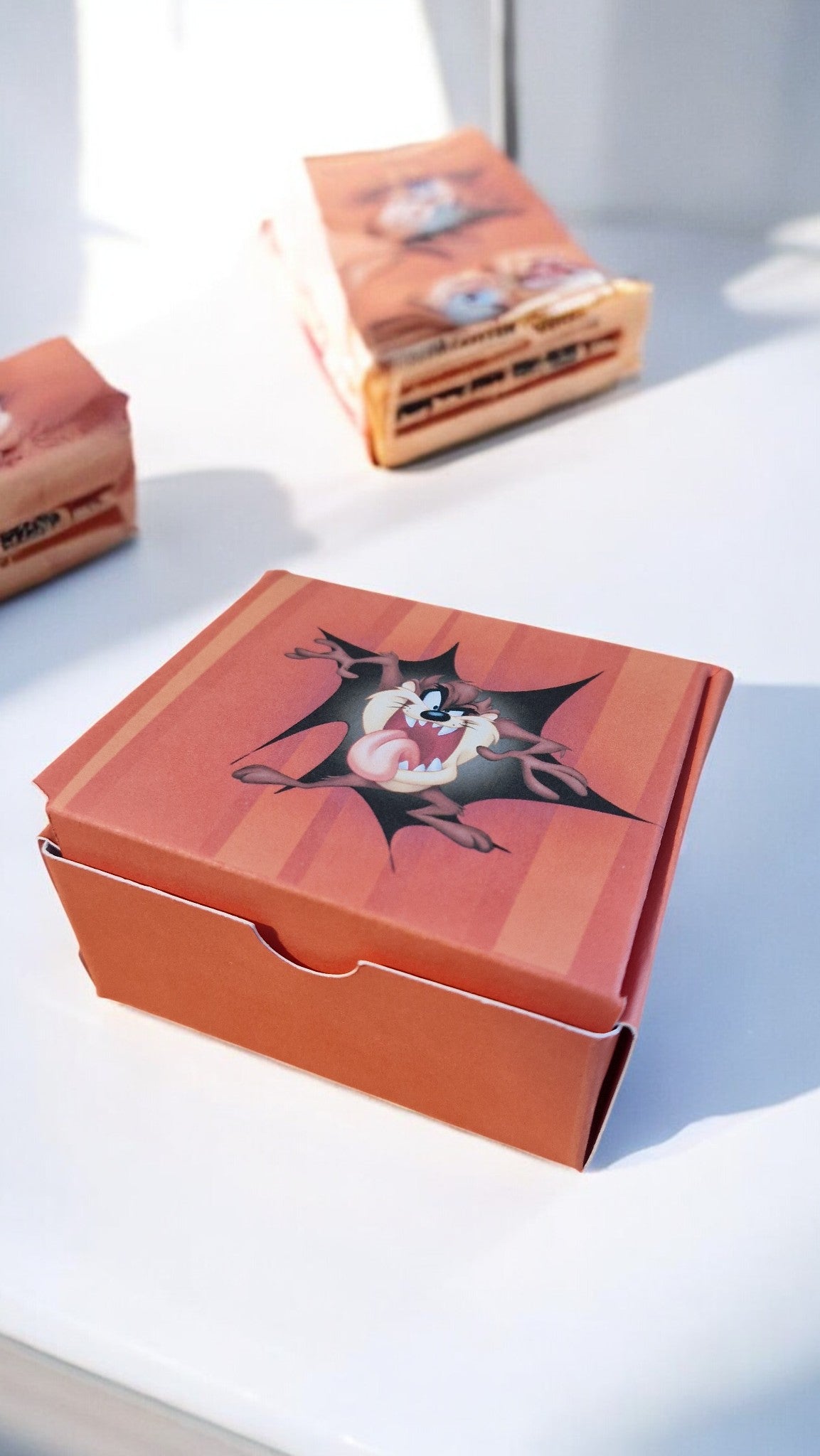 Orange boxes with black and white designs on a light gray background
