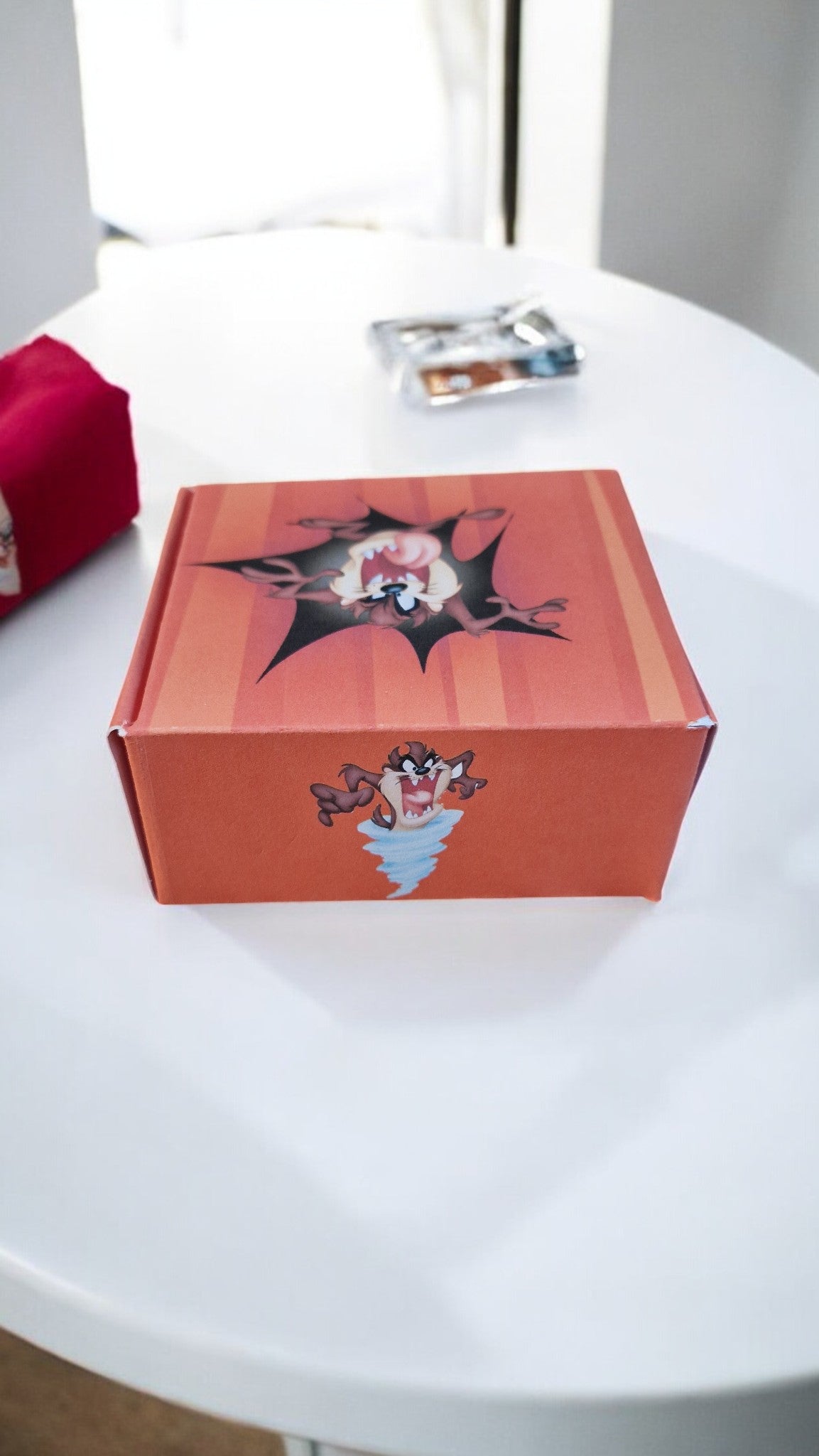 Red box with a graphic design on a white surface
