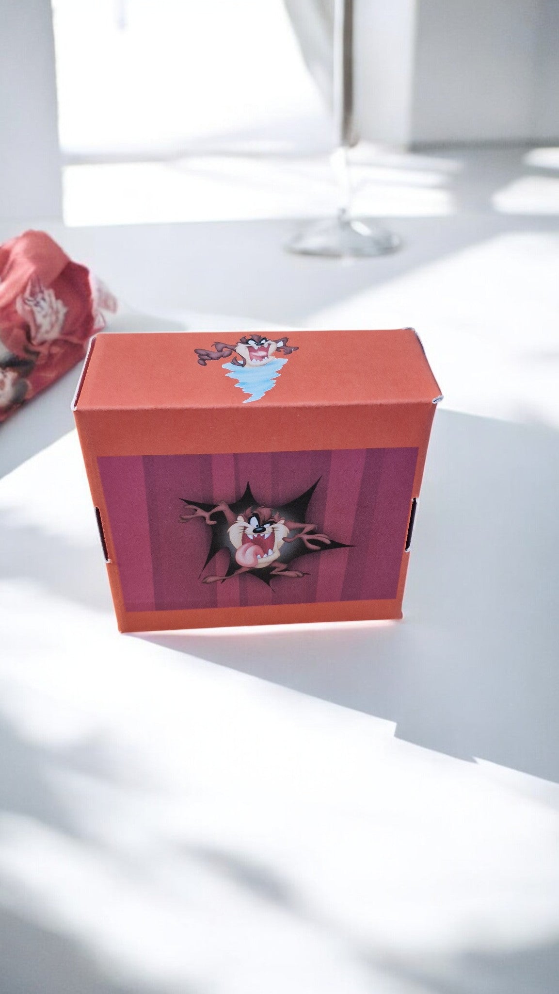 Cartoon character design on a red box with a white background