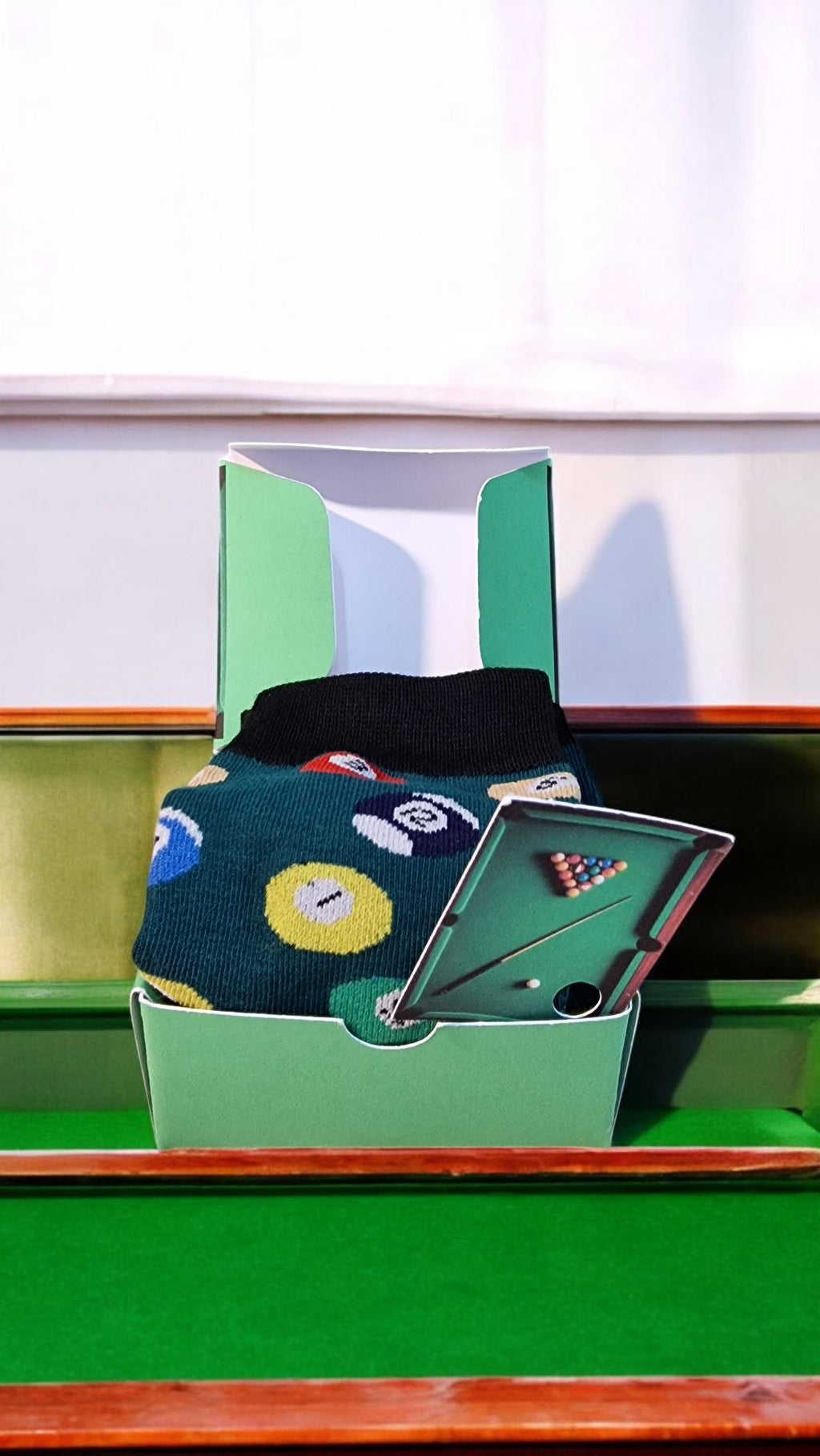 Miniature pool table with accessories on a green felt surface