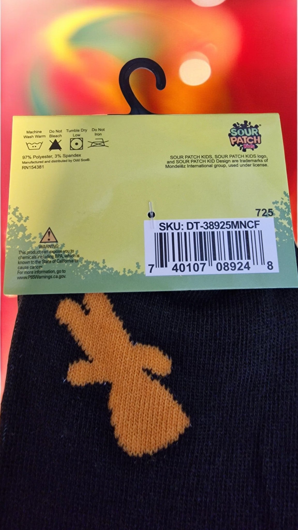 Back of a sock with a brand label and barcode on a colorful background