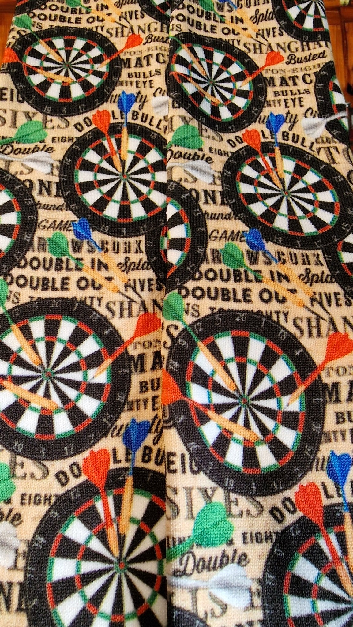 Dartboard pattern with darts on a textured background