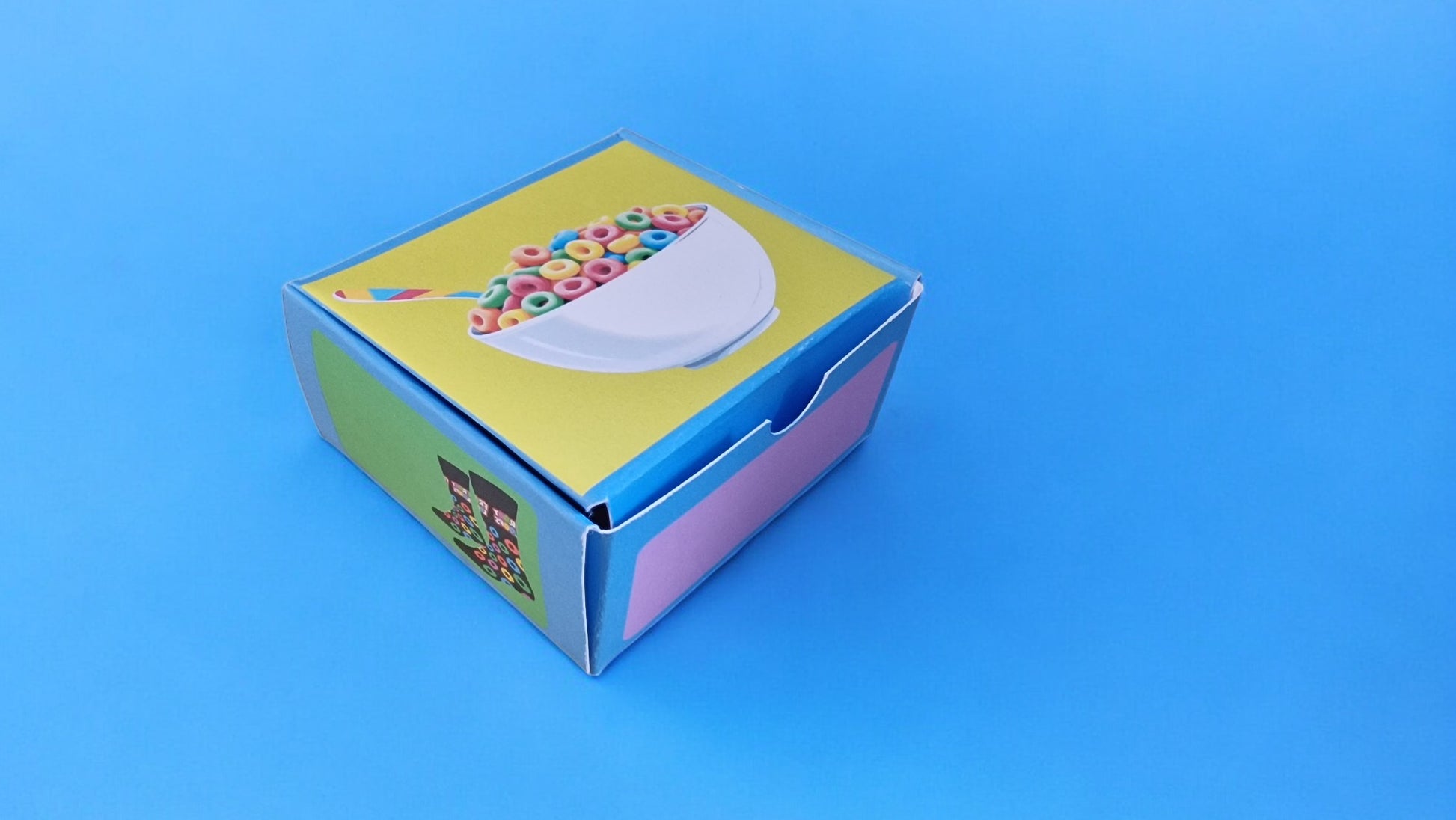 Small cardboard box with colorful design on a blue background