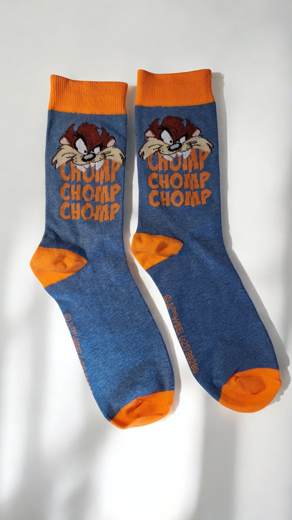 Blue socks with orange accents and cartoon character on a white background