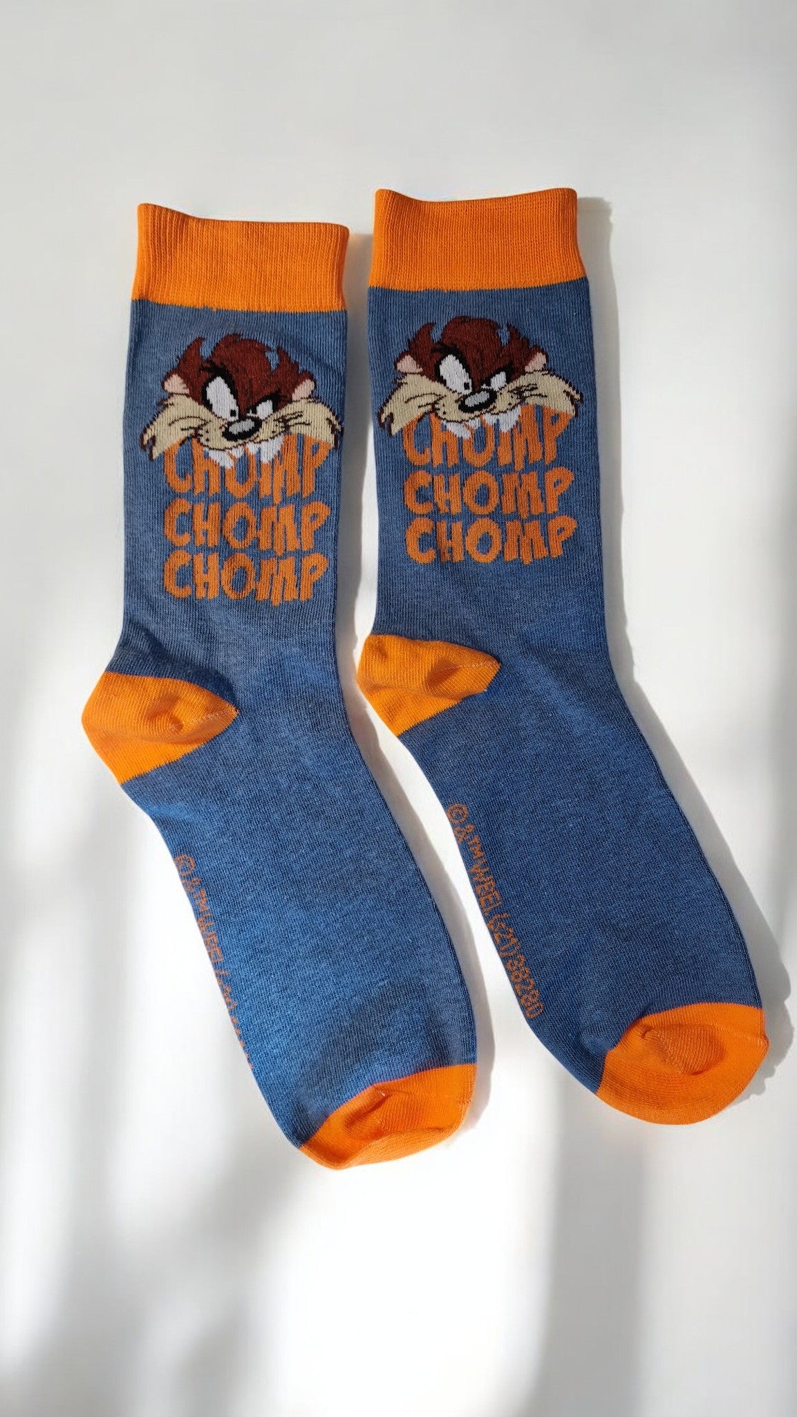 Blue socks with orange accents and cartoon character on a white background