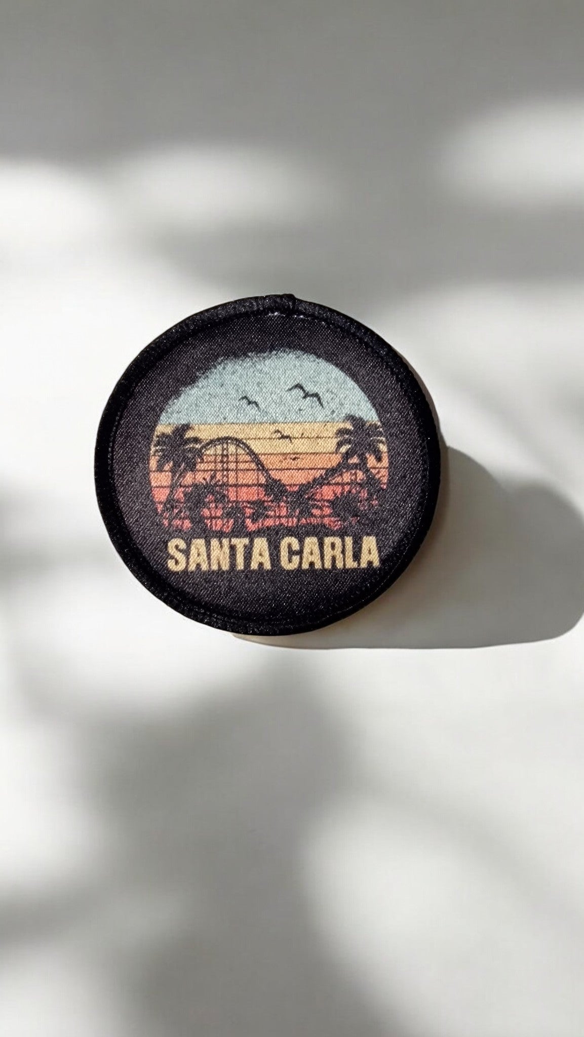 Round patch with 'Santa Carla' design on a light background