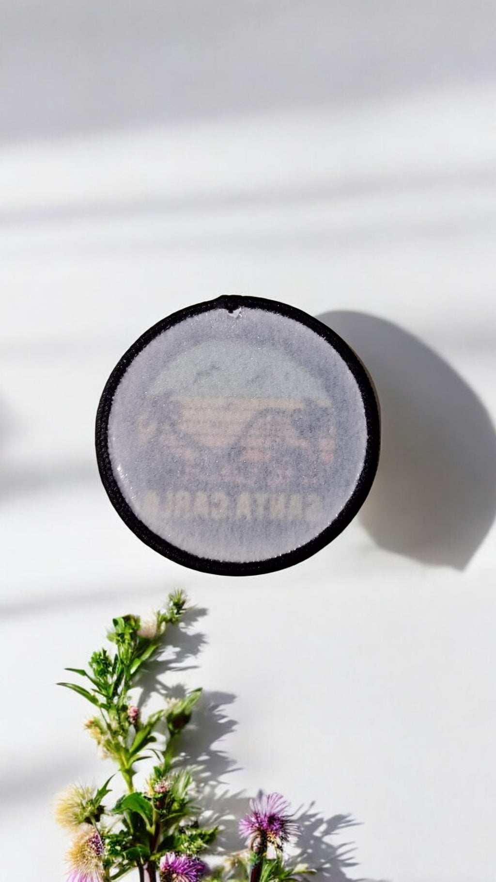 Round black object with text on a white background