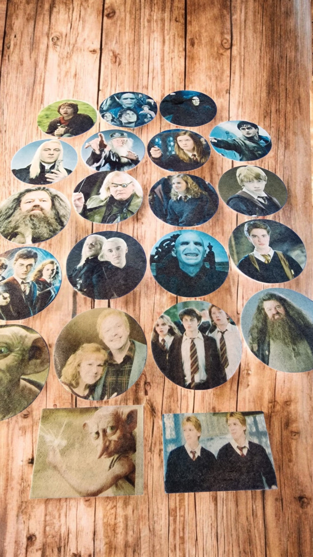 Collection of circular images of people arranged on a wooden surface