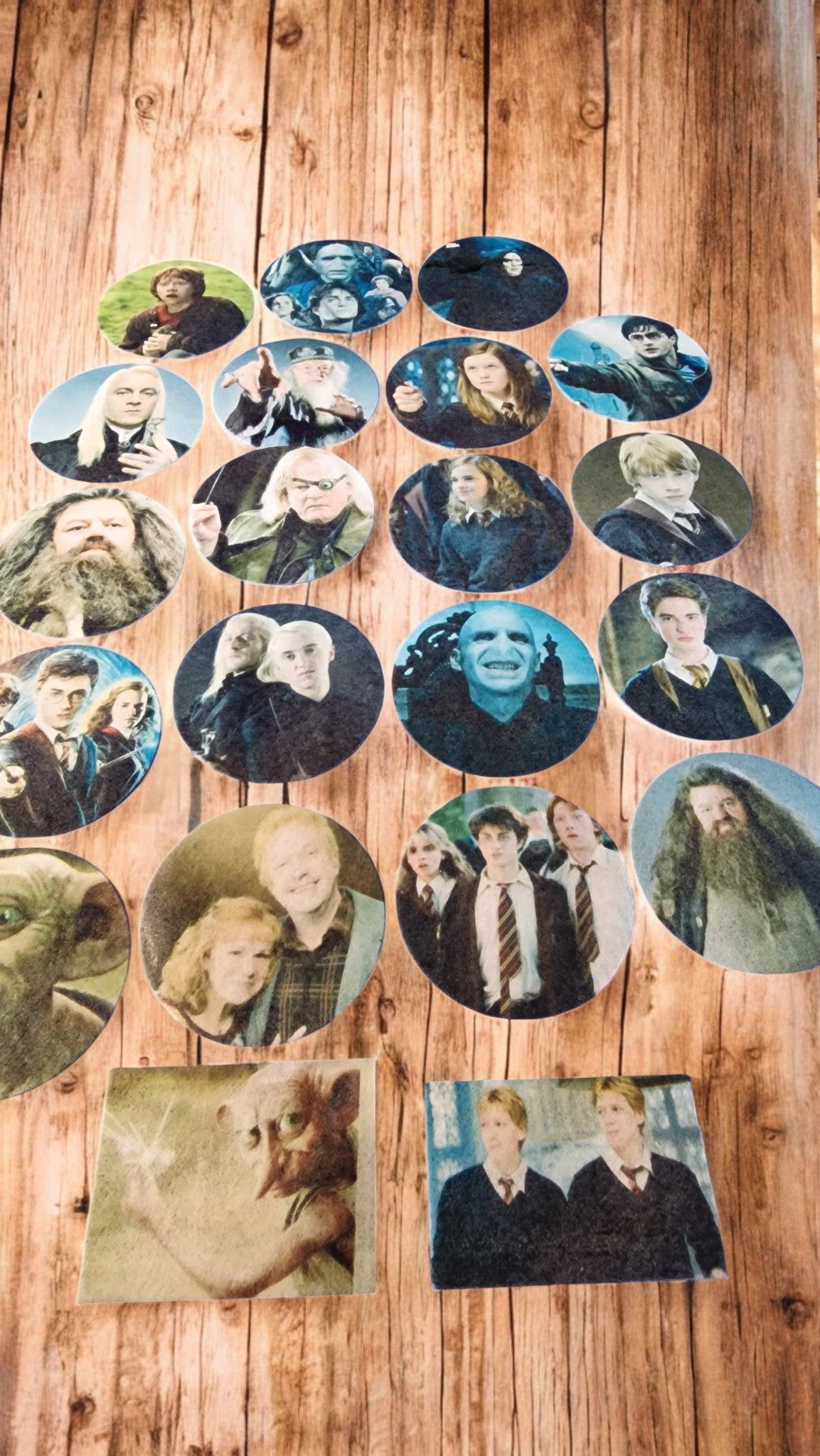 Collection of circular images of people arranged on a wooden surface