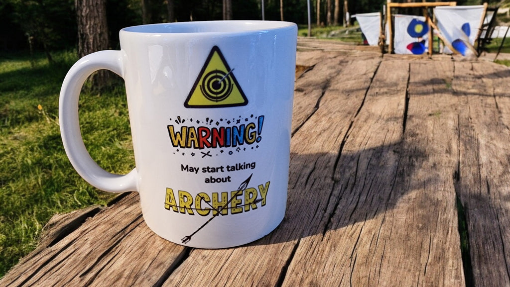 Mug with archery-themed text on a wooden surface outdoors