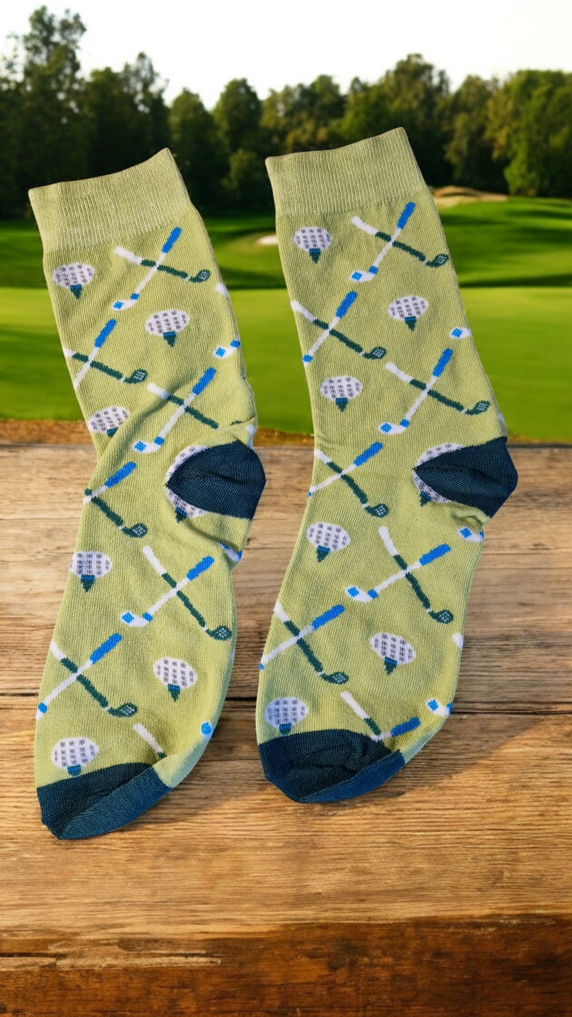 Golf-themed socks with club and ball pattern on a wooden surface with a golf course background.
