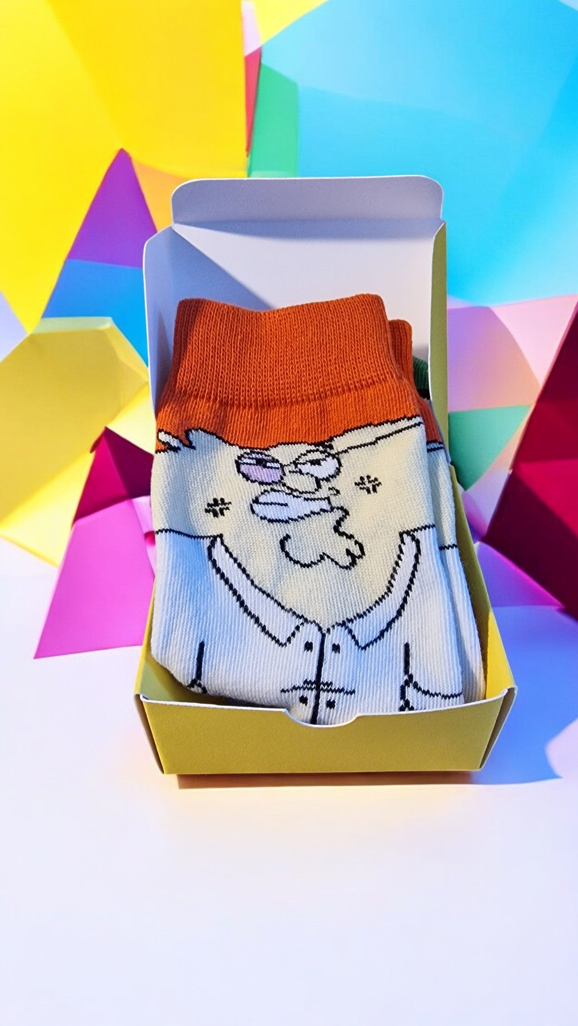 Colorful sock with cartoon design in a box against a multicolored geometric background