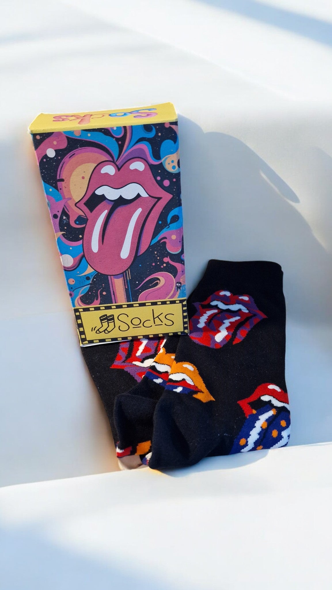 Pair of socks with colorful designs on a white surface