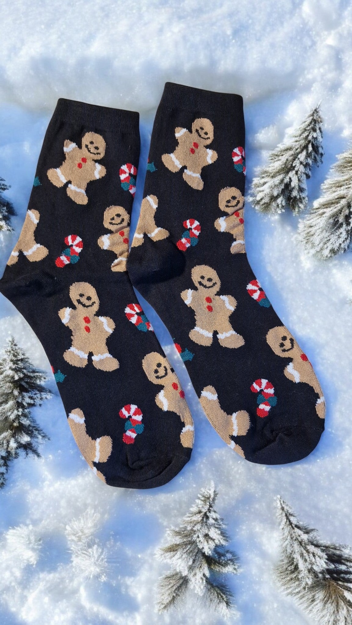 Black socks with gingerbread man pattern on a snowy background