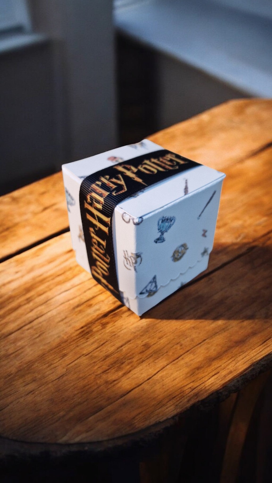 Box of Harry Potter-themed playing cards on a wooden surface