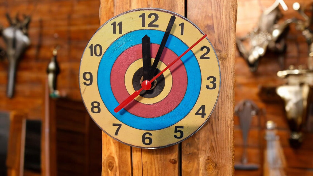 Clock designed like a target with numbers on a wooden background