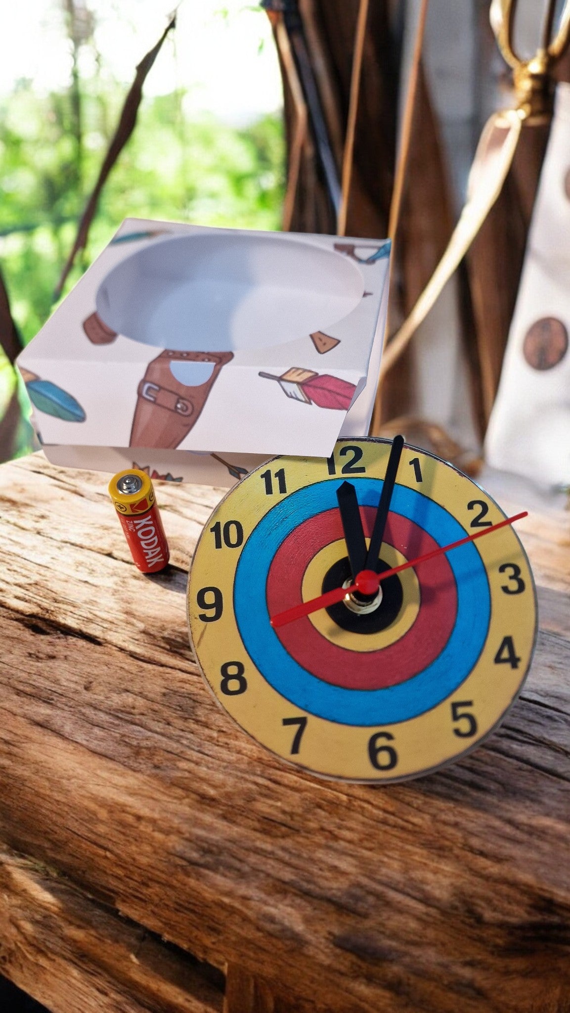 Colorful clock with a target design on a wooden surface