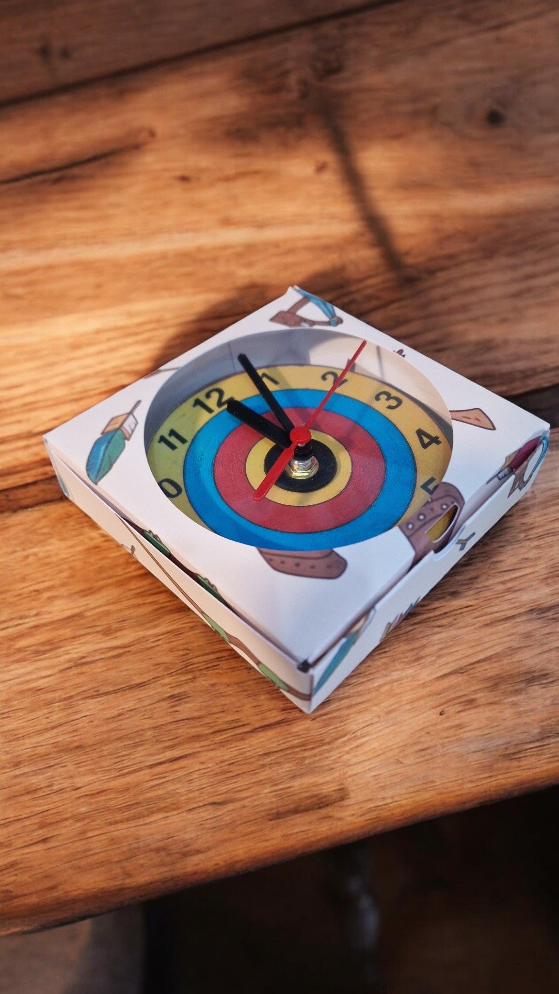 Children's toy with a dartboard design on a wooden surface