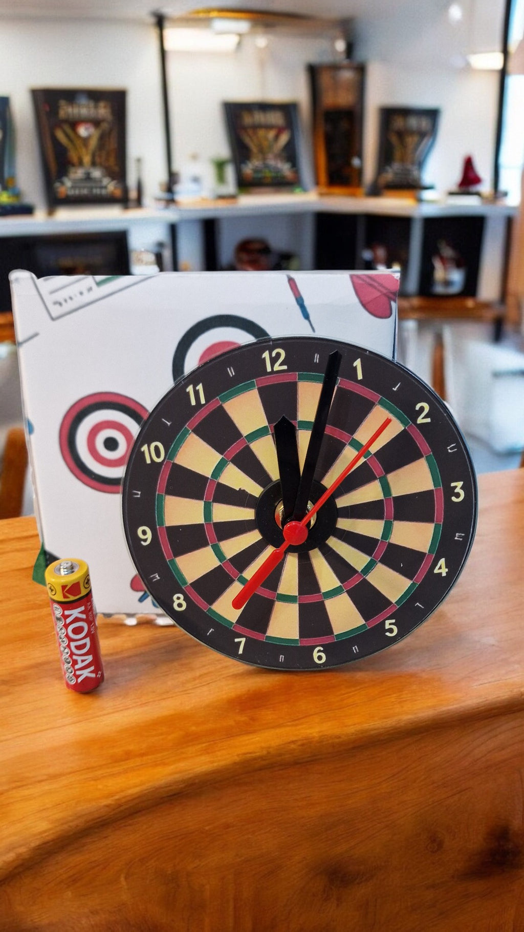 Dartboard with darts on a wooden surface in an indoor setting