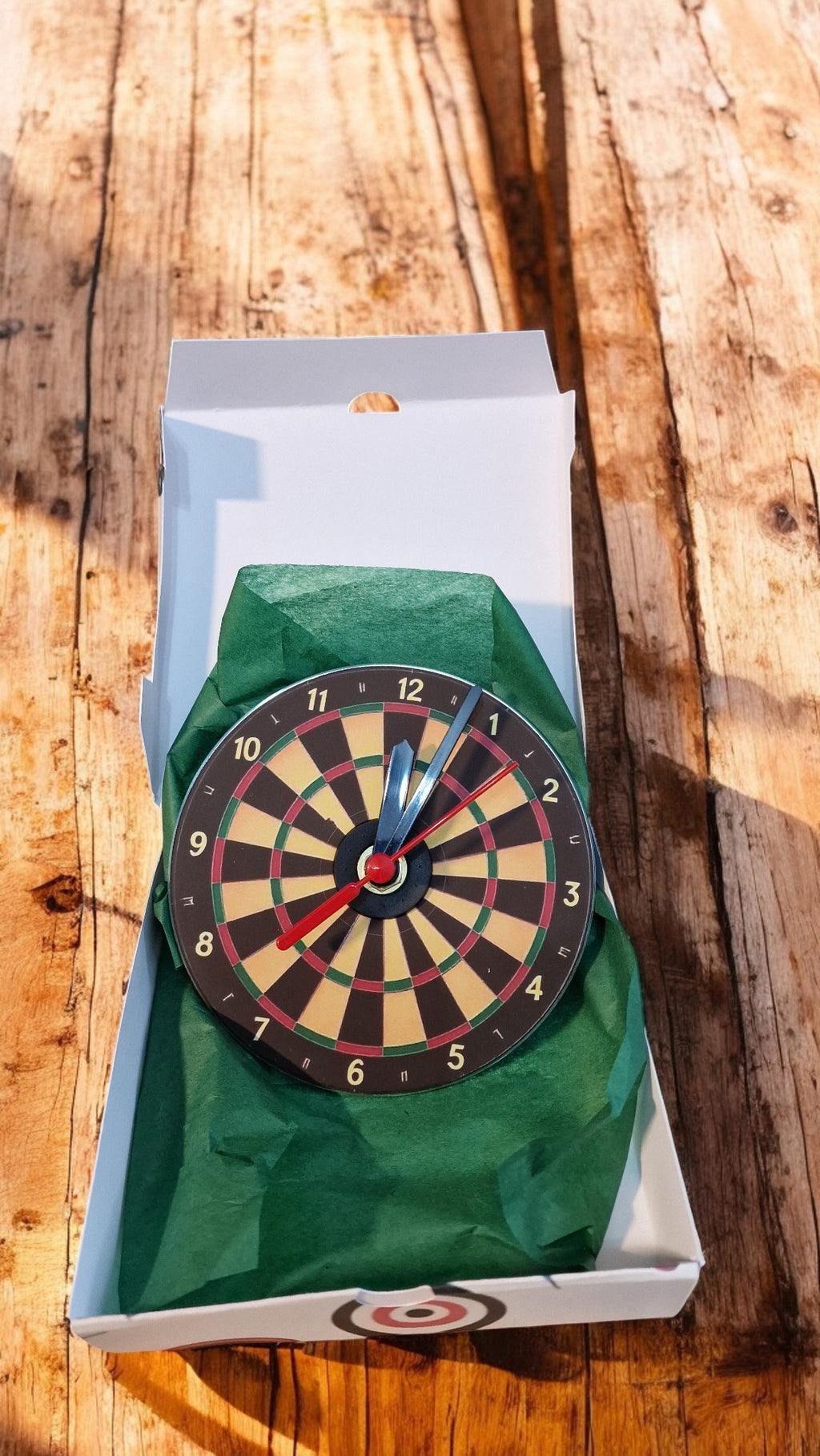 Dartboard in a box on a wooden surface