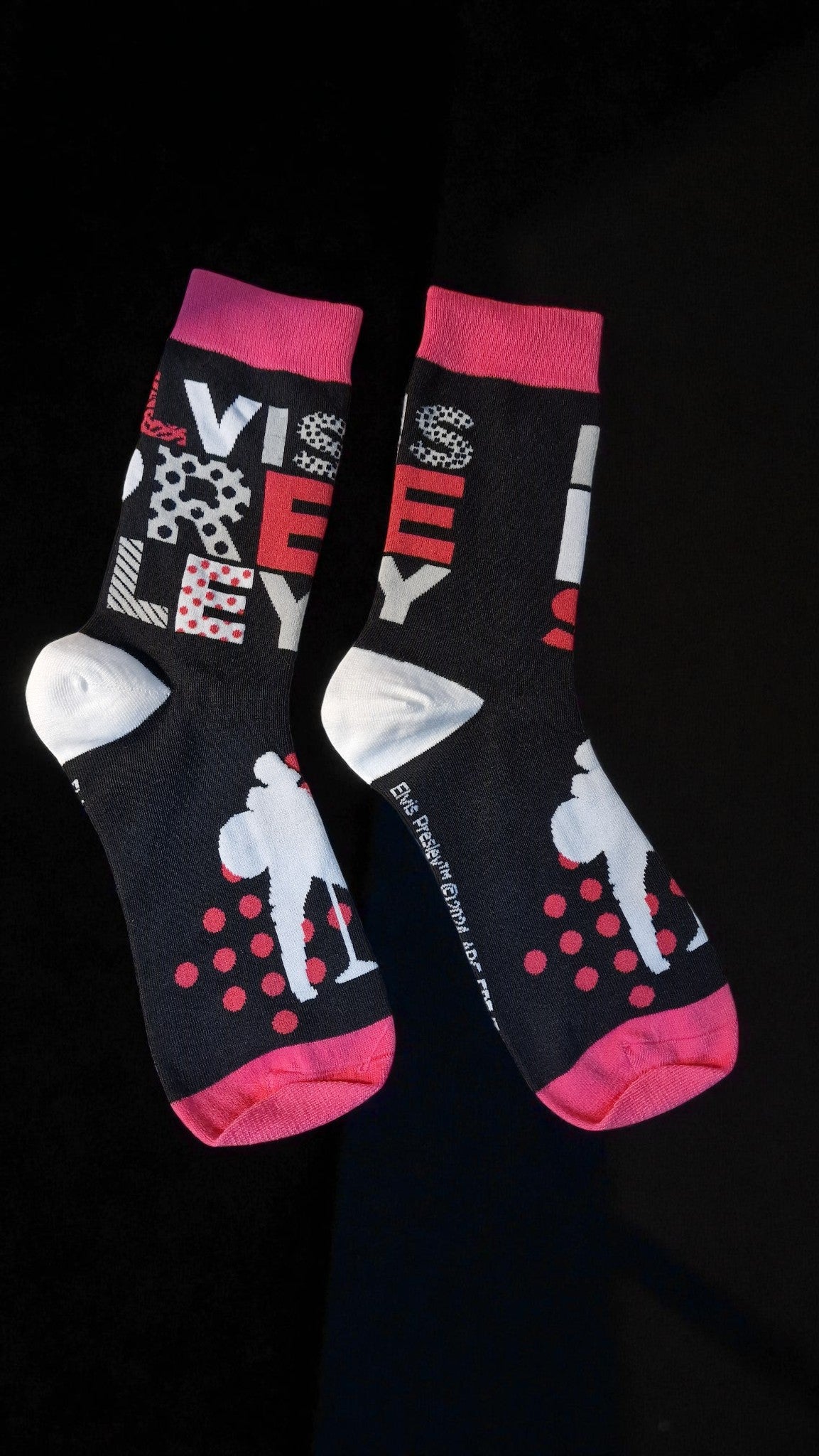 Two socks with colorful designs on a black background