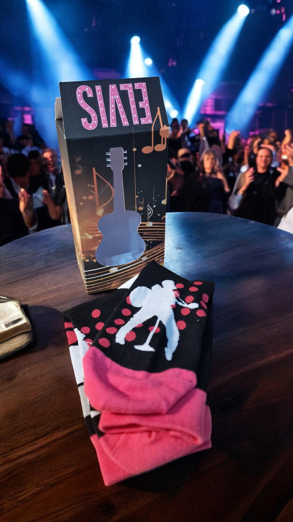 Pair of socks with a design on a table with a 'Slade' album in the background