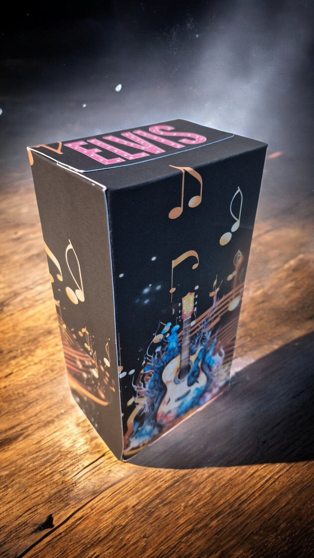 Box with 'ELVIS' branding on a wooden surface