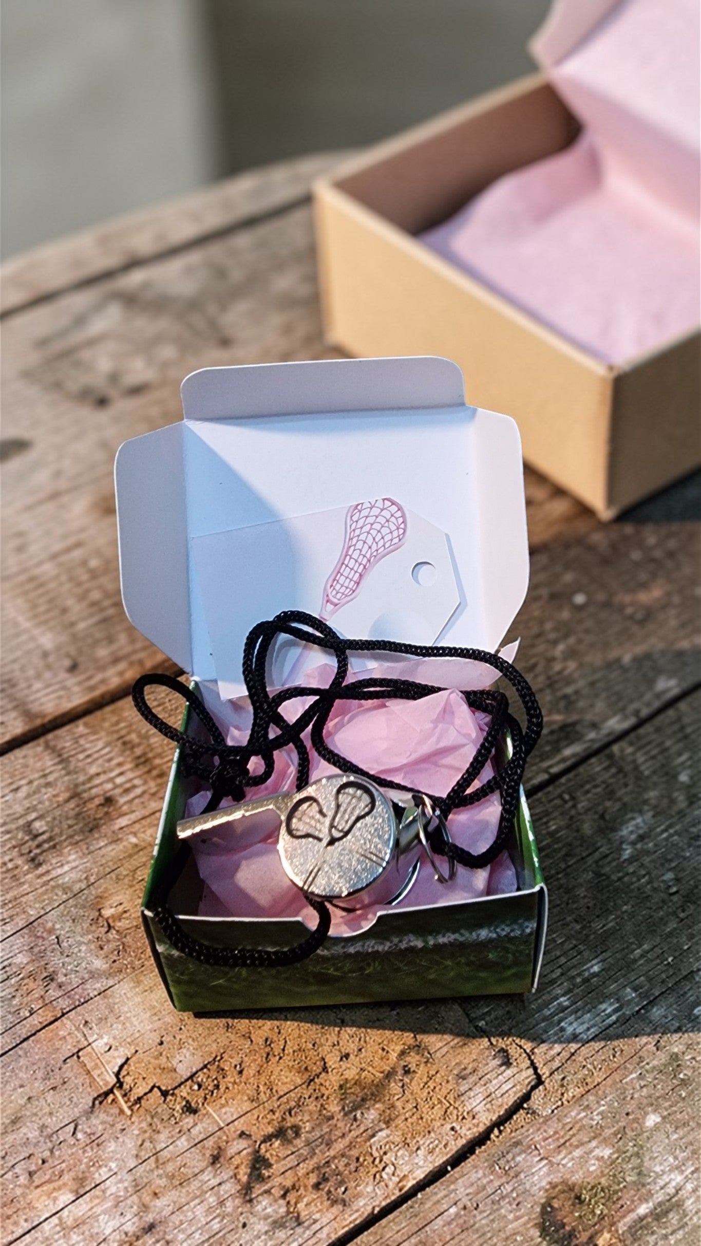 Necklace with a heart pendant in a small box on a wooden surface