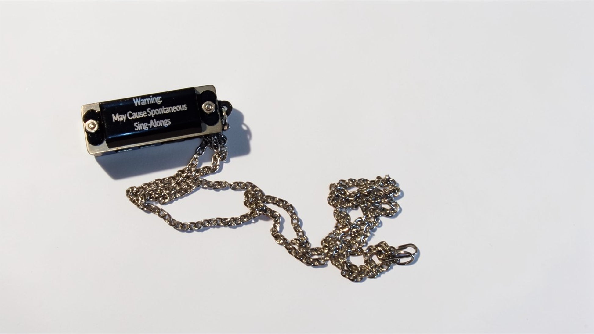 Metallic device with a chain on a white background