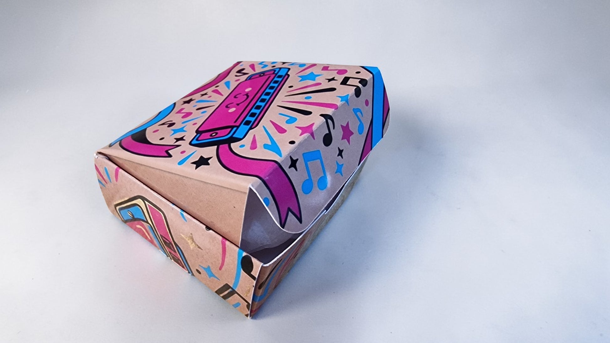 Colorful box with musical design on a light gray background