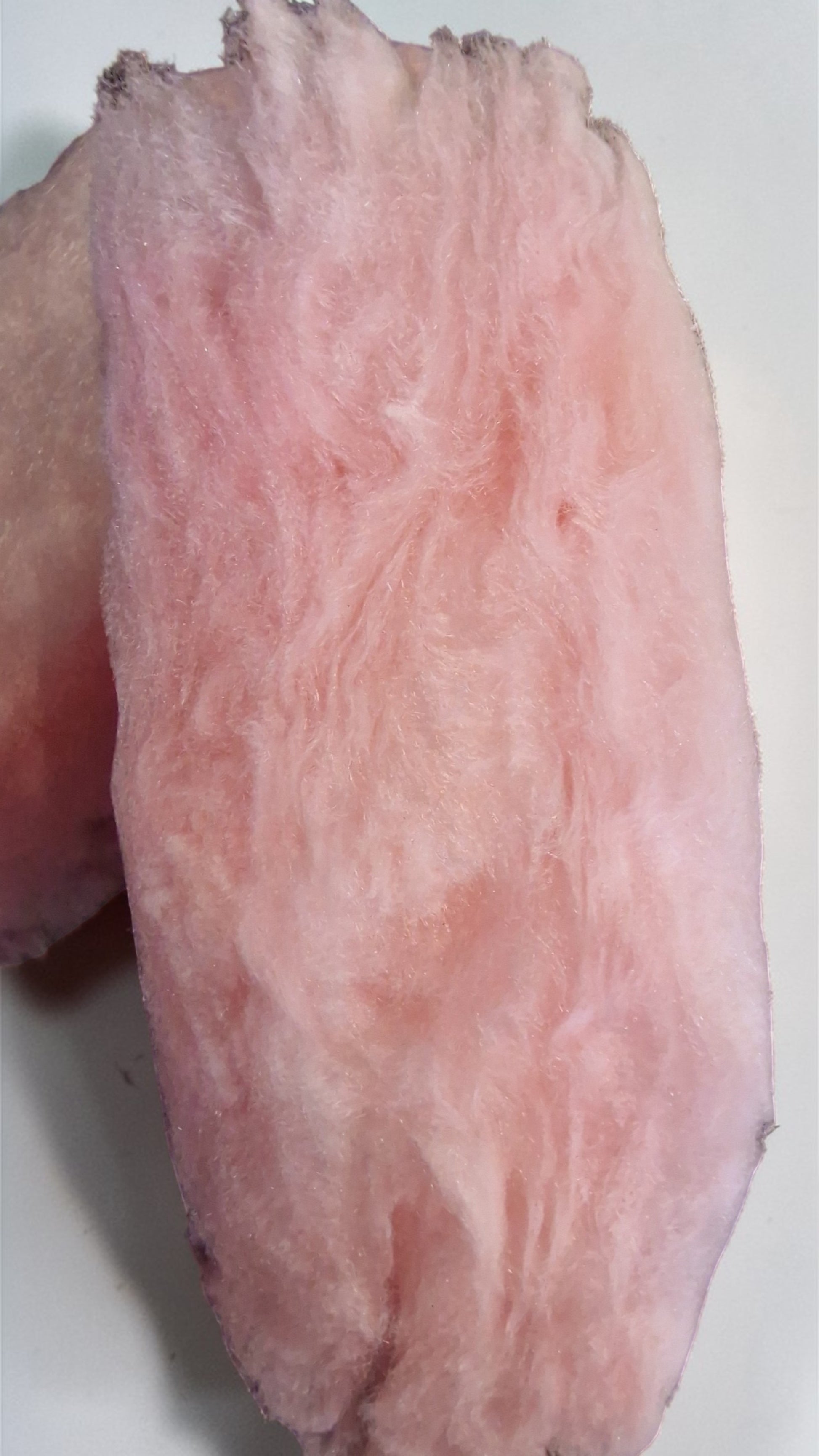 Close-up of a pinkish-white root vegetable on a white background