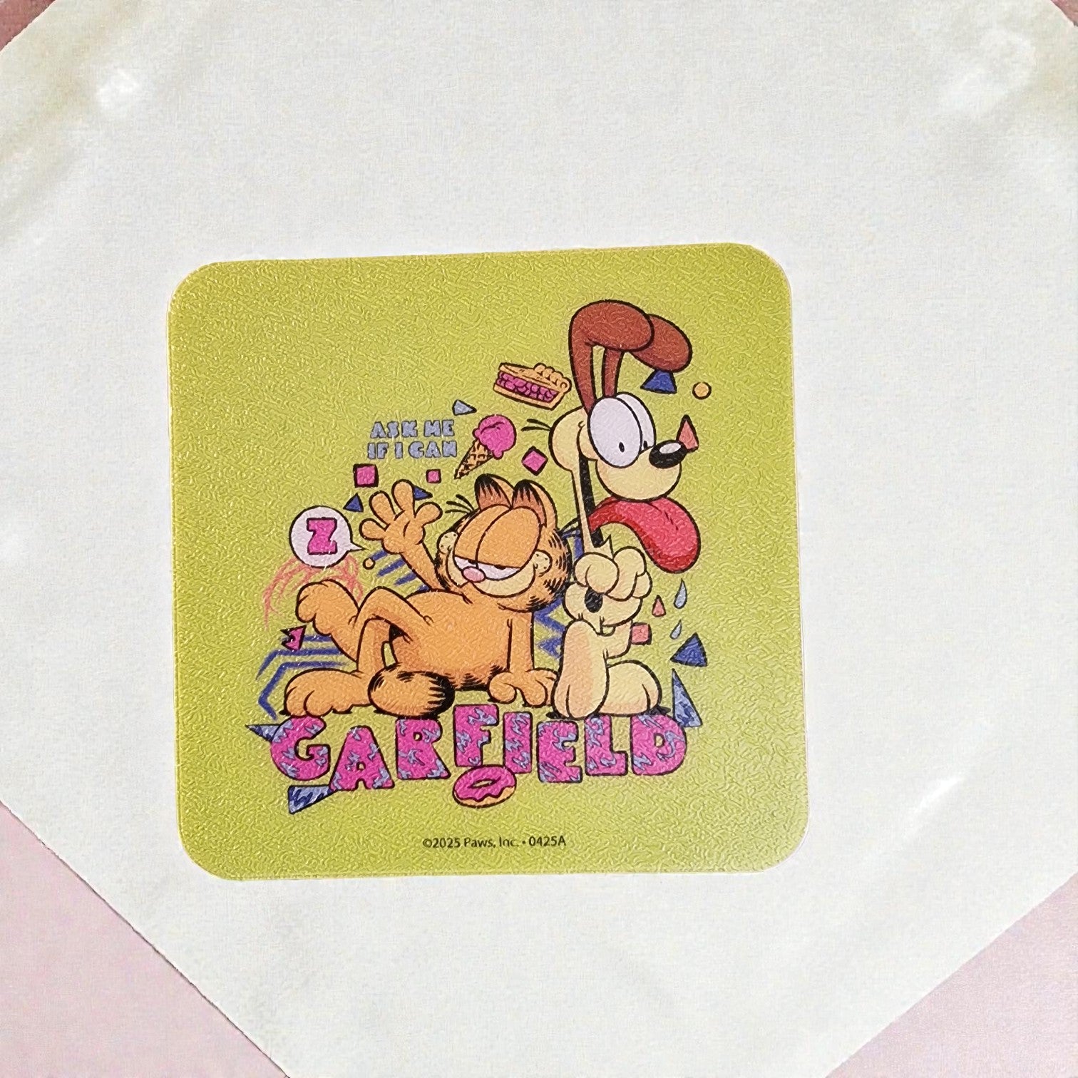 Coaster with Garfield and Odie cartoon characters on a light green background