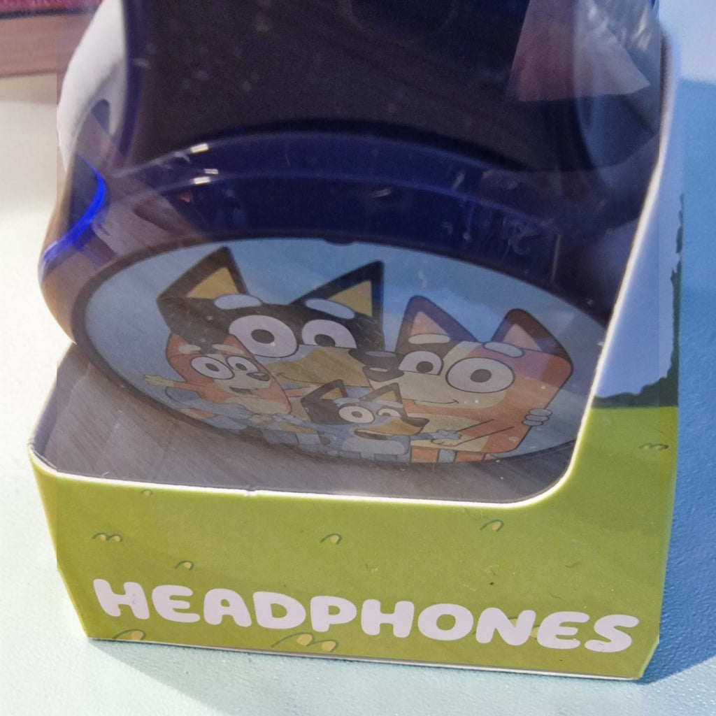 Children's headphones in a box with cartoon characters on a blue surface