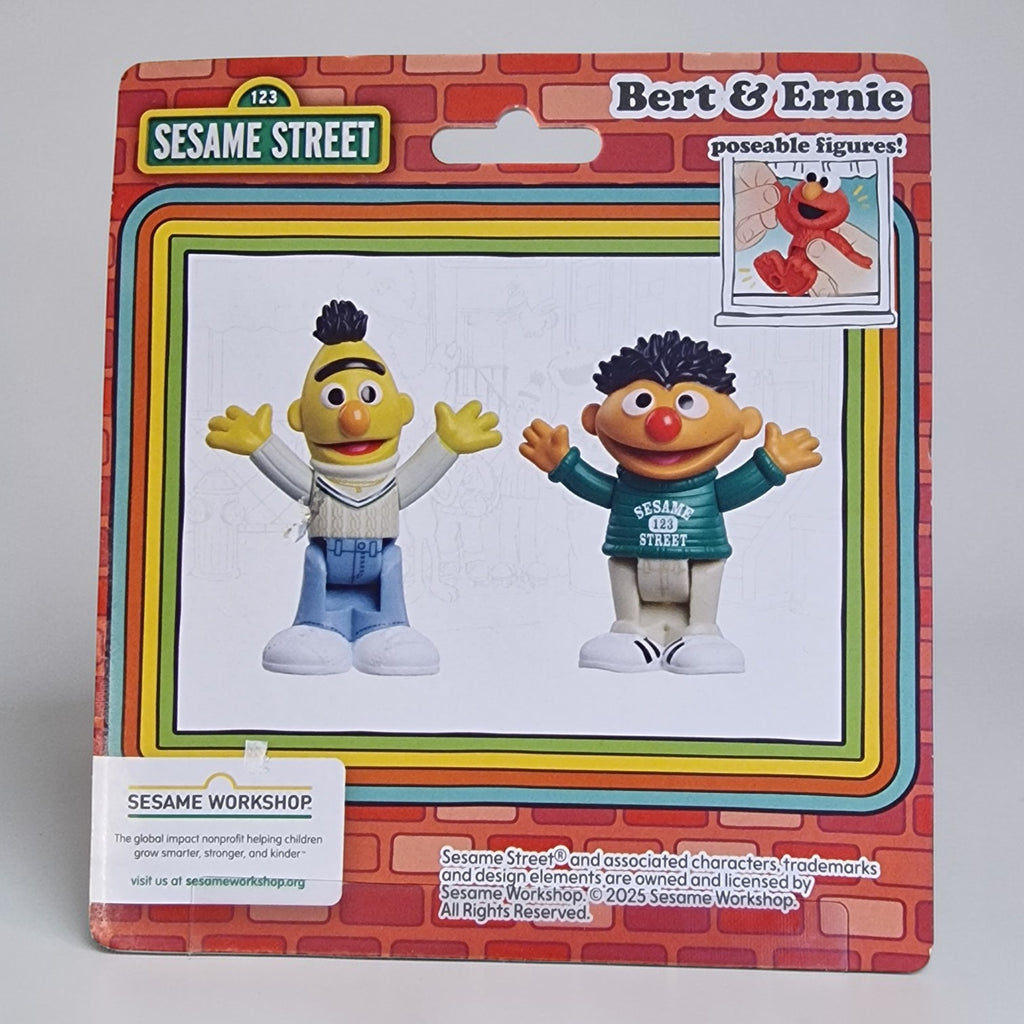 Packaged Sesame Street figures Bert and Ernie on a gray background