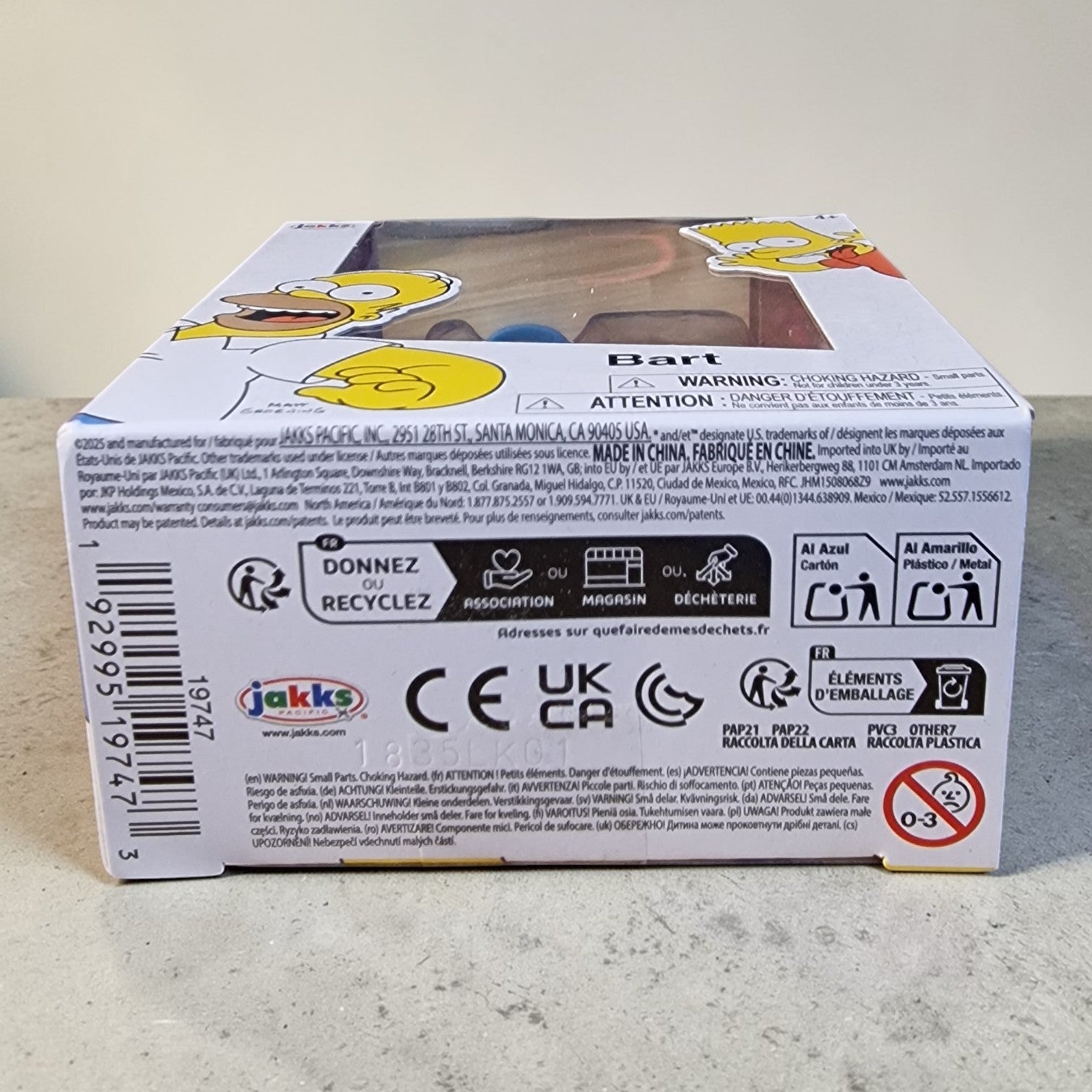 Back of a box with cartoon character images and branding on a neutral background